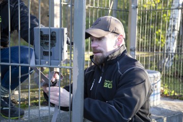 Zookeeper zetting up the trail camera for research project