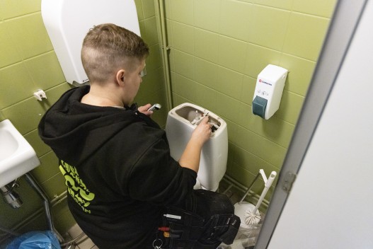 Zoo's maintenance worker fixing a leaking toilet